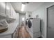 Laundry room with modern appliances, white cabinets and countertops at 10875 131St St, Largo, FL 33774