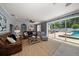 A bright living room with a sliding glass door leading to the pool area at 10875 131St St, Largo, FL 33774