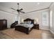 Well-lit main bedroom with a tray ceiling, a ceiling fan, and plantation shutters at 10875 131St St, Largo, FL 33774