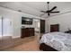 Main bedroom with wood floors, a ceiling fan, and access to the bathroom at 10875 131St St, Largo, FL 33774