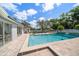 Backyard pool area with lush landscaping and ample seating at 10875 131St St, Largo, FL 33774