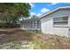 Exterior view of the home's sunroom and backyard area with partial fencing and shade at 11130 White Oak Ln, Port Richey, FL 34668