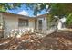 Exterior view of home and access to sunroom from the backyard, plus a small patio at 11130 White Oak Ln, Port Richey, FL 34668