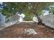 View of the backyard, partial fencing and home's sunroom, as viewed from the yard at 11130 White Oak Ln, Port Richey, FL 34668