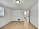 Bright bedroom features light, wood-look flooring, fresh white walls and entry to ensuite bathroom at 11130 White Oak Ln, Port Richey, FL 34668