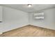 Bedroom featuring natural light, light wood flooring, and a single window at 11130 White Oak Ln, Port Richey, FL 34668