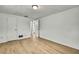 Bright bedroom features light, wood-look flooring, fresh white walls, closet and bathroom access at 11130 White Oak Ln, Port Richey, FL 34668