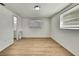 Cozy bedroom featuring light wood flooring and access to an ensuite bathroom at 11130 White Oak Ln, Port Richey, FL 34668