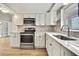 The renovated kitchen boasts modern stainless appliances and new cabinets at 11130 White Oak Ln, Port Richey, FL 34668