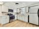 The renovated kitchen boasts modern stainless appliances and new cabinets at 11130 White Oak Ln, Port Richey, FL 34668