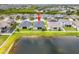 Aerial view of a home with a large backyard and a serene lake, surrounded by a white picket fence at 11522 Sunburst Marble Rd, Riverview, FL 33579