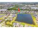 An aerial view of a suburban neighborhood featuring a scenic lake and well-maintained homes at 11522 Sunburst Marble Rd, Riverview, FL 33579