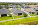 Aerial view of a home with a large, grassy backyard enclosed by a white fence, backing onto a tranquil lake at 11522 Sunburst Marble Rd, Riverview, FL 33579