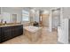 This primary bathroom showcases a garden tub, granite counters, and tiled walk-in shower at 11522 Sunburst Marble Rd, Riverview, FL 33579