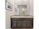 Bathroom featuring a double sink vanity with a granite countertop and framed mirror at 11522 Sunburst Marble Rd, Riverview, FL 33579