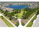 Aerial shot of a well-maintained community park surrounded by lush greenery and a serene lake at 11522 Sunburst Marble Rd, Riverview, FL 33579