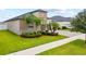 Beautiful single-Gathering home showcasing manicured landscaping with palm trees and a spacious paved driveway at 11522 Sunburst Marble Rd, Riverview, FL 33579
