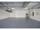 Epoxy floored garage featuring a Kayak hoist, water heater and electrical panel at 11522 Sunburst Marble Rd, Riverview, FL 33579