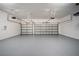 Spacious two-car garage featuring epoxy flooring, multiple garage doors and lighting fixtures at 11522 Sunburst Marble Rd, Riverview, FL 33579