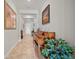 Elegant hallway featuring tiled floors, crown molding, decorative art, and a stylish piano at 11522 Sunburst Marble Rd, Riverview, FL 33579