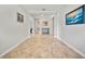 Hallway featuring tile flooring, crown molding, and decorative wall art at 11522 Sunburst Marble Rd, Riverview, FL 33579