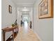 Inviting hallway featuring neutral colors, tile flooring, elegant decor, and ample natural light at 11522 Sunburst Marble Rd, Riverview, FL 33579