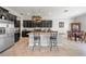 Stylish kitchen with stainless steel appliances, dark cabinetry, and a granite countertop island with seating at 11522 Sunburst Marble Rd, Riverview, FL 33579
