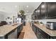 Well-equipped kitchen with granite countertops, stainless steel appliances, and dark cabinetry for a modern look at 11522 Sunburst Marble Rd, Riverview, FL 33579