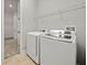 A laundry room with a wire rack and like-new washer and dryer at 11522 Sunburst Marble Rd, Riverview, FL 33579
