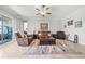 Spacious living room boasts ample seating, a ceiling fan, and tile flooring for easy maintenance and a clean look at 11522 Sunburst Marble Rd, Riverview, FL 33579