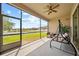 Screened in porch with ceiling fan, swing and view of the backyard at 11522 Sunburst Marble Rd, Riverview, FL 33579