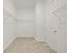 Empty walk-in closet with shelving and carpeting at 11522 Sunburst Marble Rd, Riverview, FL 33579