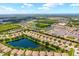 Expansive aerial view of a community with homes surrounding multiple ponds and lush green landscaping at 11559 Captiva Kay Dr, Riverview, FL 33569