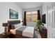 Stylish bedroom features a minimalist design and a calm view of the outside at 11559 Captiva Kay Dr, Riverview, FL 33569