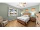 Comfortable bedroom featuring wood floors, serene lake view, and neutral color palette at 11559 Captiva Kay Dr, Riverview, FL 33569