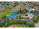 Aerial shot showcasing community amenities with pools, tennis courts, playground, parking, and landscaping at 11559 Captiva Kay Dr, Riverview, FL 33569