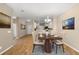 Elegant dining area with a dining table set for four, showcasing a warm and inviting atmosphere with views of the kitchen at 11559 Captiva Kay Dr, Riverview, FL 33569
