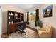 Comfortable home office with built-in shelving, a view outside, and a cozy chair at 11559 Captiva Kay Dr, Riverview, FL 33569