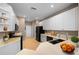 Bright kitchen with white cabinets, a black appliance suite, and a double basin sink set into light countertops at 11559 Captiva Kay Dr, Riverview, FL 33569