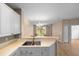 Open-concept kitchen featuring a peninsula counter and sleek stainless steel double sink, perfect for modern living at 11559 Captiva Kay Dr, Riverview, FL 33569