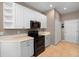 Modern kitchen with white upper cabinets, gray lower cabinets, and stainless steel appliances, beautifully designed at 11559 Captiva Kay Dr, Riverview, FL 33569