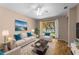 Cozy living room with a plush sofa, comfortable chairs, and a sliding glass door offering scenic views and natural light at 11559 Captiva Kay Dr, Riverview, FL 33569