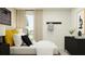 Well-organized bedroom with a sleek black dresser, modern accents, and academic wall decor at 11977 Brae Way, Dade City, FL 33525