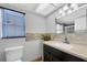 Bathroom featuring tiled backsplash, vanity with dark wood cabinets, and a window providing natural light at 12946 116Th St, Largo, FL 33778