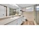 Bathroom featuring tile backsplash, vanity with white cabinets, and a glass-enclosed shower at 12946 116Th St, Largo, FL 33778