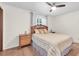 Bedroom with tiled floors, ceiling fan, and a decorative bed with striped bedding and wood furniture at 12946 116Th St, Largo, FL 33778