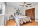 Bedroom displays tiled floors, ceiling fan, two windows, and a decorative bed with an iron headboard at 12946 116Th St, Largo, FL 33778