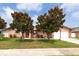 Inviting single-story home with mature magnolia trees in the front yard, and featuring an attached two car garage at 12946 116Th St, Largo, FL 33778
