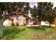 Charming single-story home featuring a well-manicured lawn and mature magnolia trees with a stone accent entry at 12946 116Th St, Largo, FL 33778