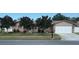 Traditional single-story home with a two-car garage, a well-maintained lawn and mature trees at 12946 116Th St, Largo, FL 33778